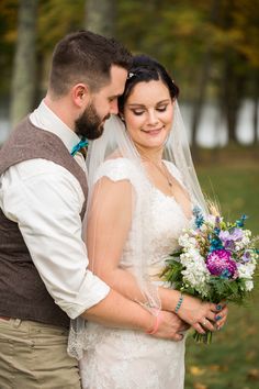 a bride and groom pose for a wedding photo