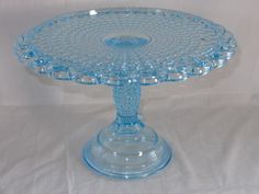 a blue glass cake plate on a white background