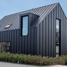 a black building with two windows on the side