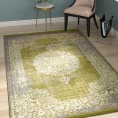 a green area rug with an ornate design on the center in a living room setting