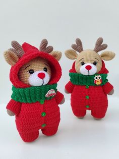 two stuffed animals dressed in red and green clothing