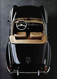 an overhead view of a black car with tan leather seats