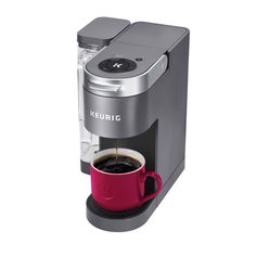 keuric single serve coffee maker with red cup and black handle, on white background