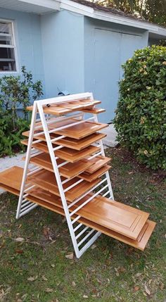 a stack of wooden trays in front of a house