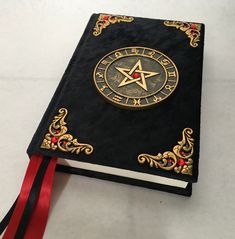 Hand crafted Book of shadows journal. Journal is covered in a black velvet fabric with gold antiqued Handmade resin trims and 13 sparkly red Crystal gems. Journal has thick blank of white sketch book paper with 4 silky ribbon dividers . Journal measures 8 1/2"X 5 3/4" inches. Thank you for looking please check out my other items I have more treasures available Wiccan Journal, Wiccan Alter, Book Of Shadows Journal, Potions Book, Black Velvet Fabric, Witch Gift, How To Age Paper, Altered Boxes