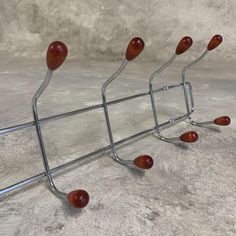 a metal rack with several red apples on it's sides and one is upside down