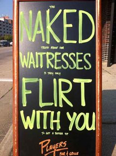 a sign on the sidewalk that says naked waitresses flirt with you