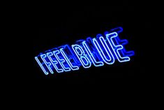 a neon sign that reads feel blue