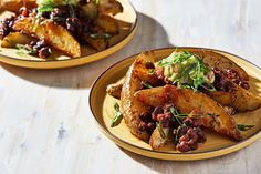 two plates filled with food sitting on top of a wooden table next to each other