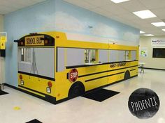 the school bus is painted yellow and has no wheels on it's side,