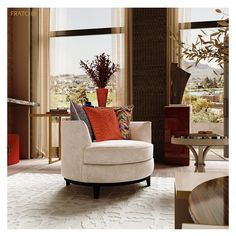 a living room filled with furniture and a large window covered in lots of natural light