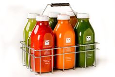 four bottles of juice in a wire basket