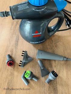 several different types of hair dryers on a wooden floor next to some wires and plugs