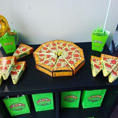 a table topped with green bags and pizza slices