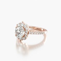 a yellow gold engagement ring with an oval cut diamond surrounded by small round brilliant diamonds