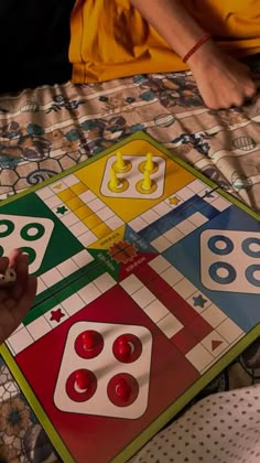 two people playing a board game on a bed