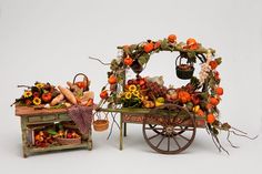 an old wagon filled with lots of fruit and veggies next to a small table