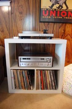 an entertainment center with various records on it