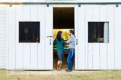 a man and woman standing in the doorway of a shed