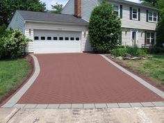 a brick driveway in front of a house