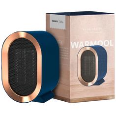 the blue and gold speaker is next to a cardboard box with it's lid open