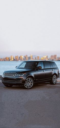 a range rover parked next to the water