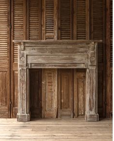 an old fireplace with wooden shutters in a room