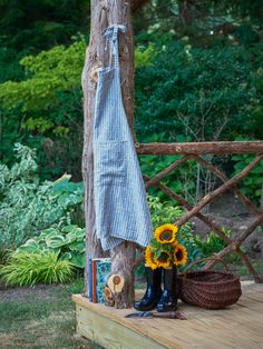 the sunflowers are sitting on the bench next to the towel and boot boots