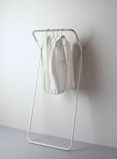 an ironing board with clothes hanging on it