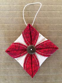 a red and white ornament with a button on it