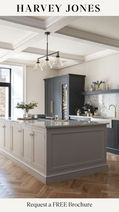 an image of a kitchen with gray cabinets and white counter tops, in the middle of a wooden floor