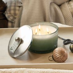 a lit candle sitting on top of a tray