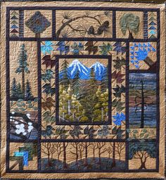 a quilted wall hanging with trees and mountains