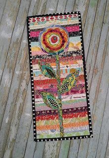 a patchwork quilt with a flower on it