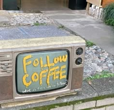 an old tv sitting on top of a sidewalk