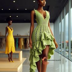 a woman is walking down the runway in a green dress