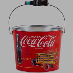 an old coca - cola bucket with the lid open