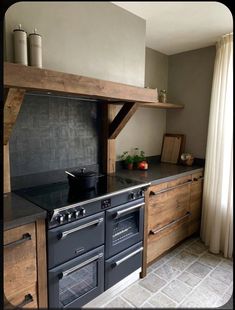 a kitchen with an oven, stove and counter top in it's center area