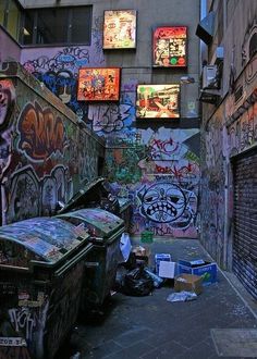 an alley with graffiti all over the walls