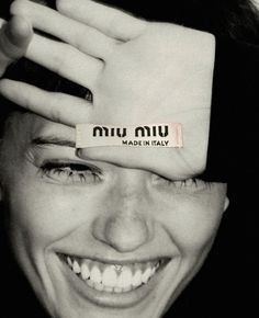 a woman with her hands on top of her head and the words made in italy