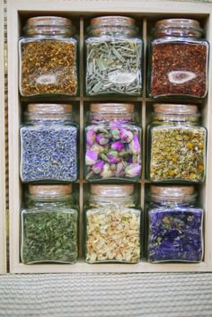 a wooden box filled with lots of different types of herbs