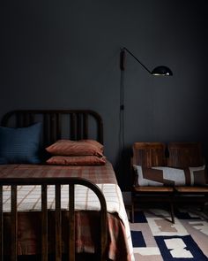 a bed sitting in a bedroom next to a lamp