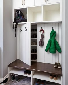 an image of a room with shoes and coat racks on the wall in front of it