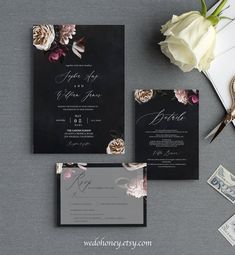 the wedding stationery is laid out on top of an envelope, and there are flowers