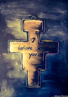 a cross with the words i believe you painted on it in gold and blue colors