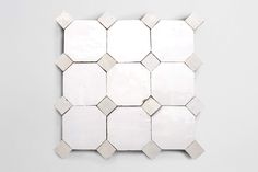 white hexagonal tiles are arranged on the wall