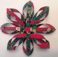 an ornament made out of strips of red and green paper