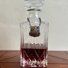 a glass bottle filled with liquid sitting on top of a wooden table