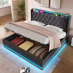 a bed with an illuminated headboard and foot board is shown in the middle of a room