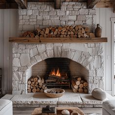 a living room filled with furniture and a fire place in front of a stone fireplace